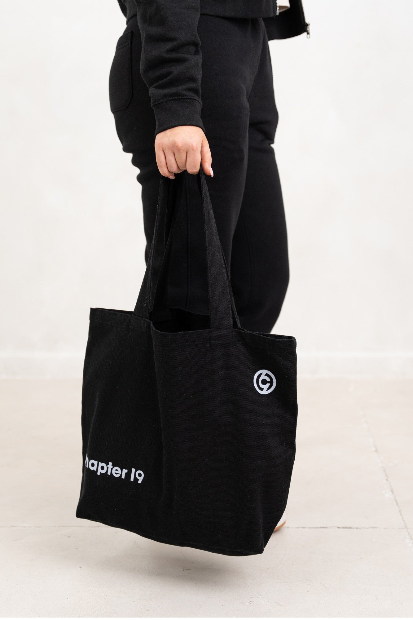 close up of chapter 19 black tote bag availabble in cream as well