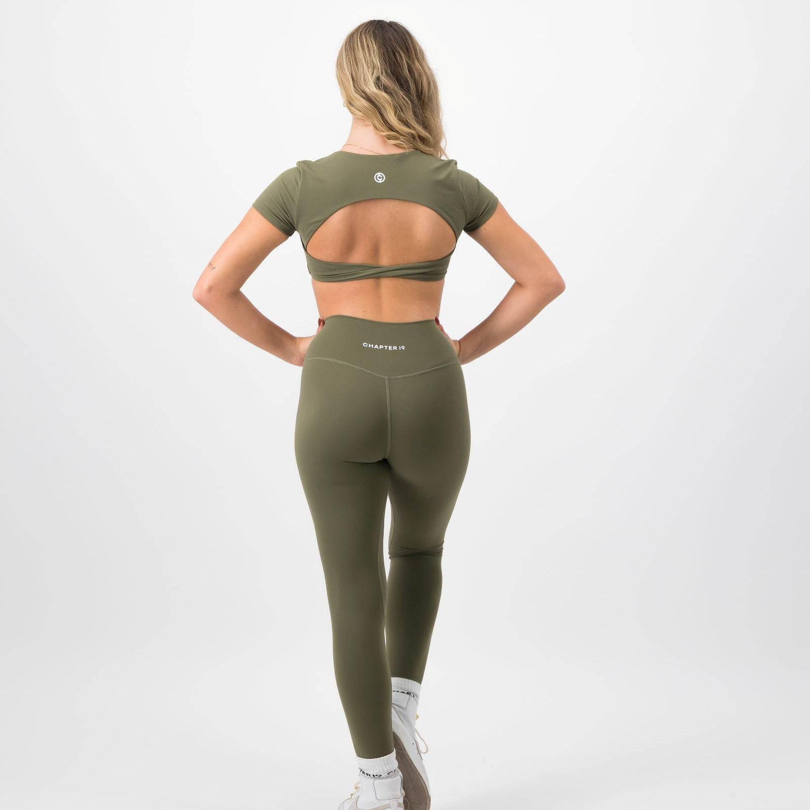 Person wearing a green athletic outfit on a white background