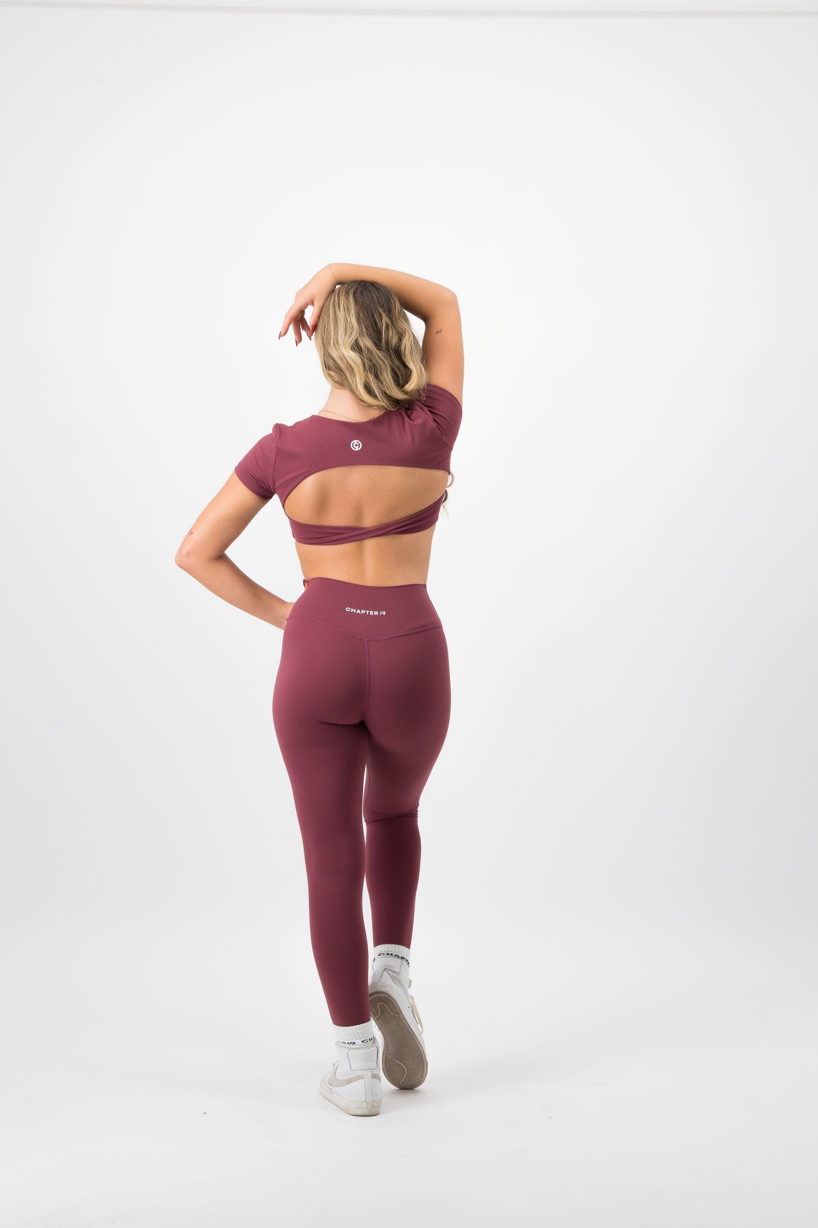 Person wearing a maroon athletic outfit on a white background